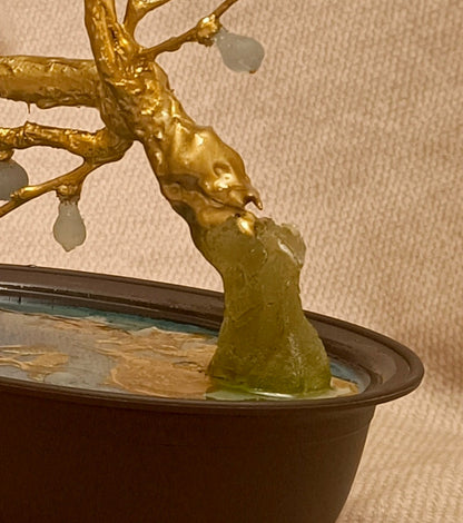 Detailed view of golden branch and translucent fig-shaped fruit